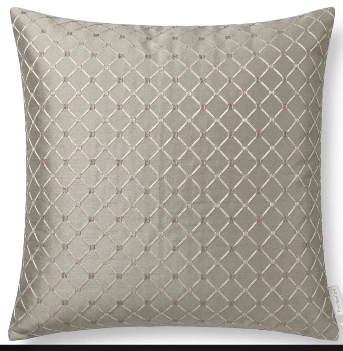 Light grey silk velvet throw pillow with geometric diamond pattern and small white label reading “Line & Politis”.