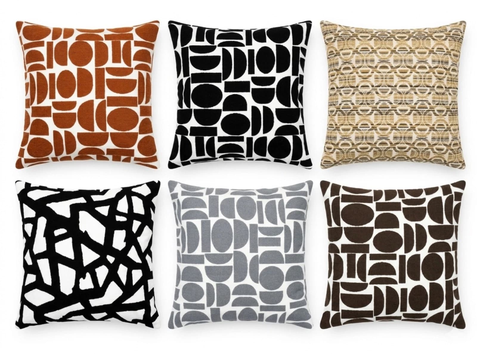 Brown, black, and beige geometric throw pillows with silver circles and squares on a textured light gray fabric background.