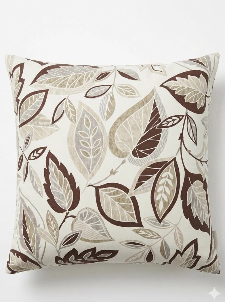 Cream beige throw pillow cover with brown and green leaf pattern, 20/20 size, on white fabric background.