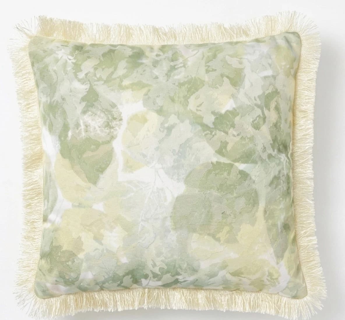 Square sage green throw pillow with yellow botanical print and fringe trim, 18/18 scale.