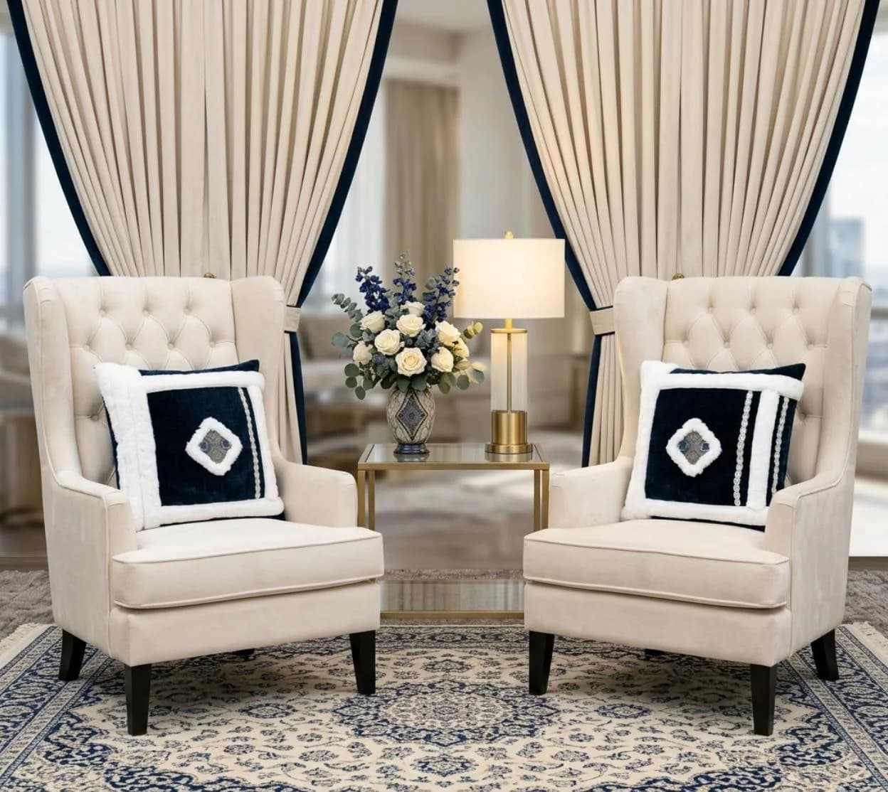 Navy and white framed pillows on cream chairs