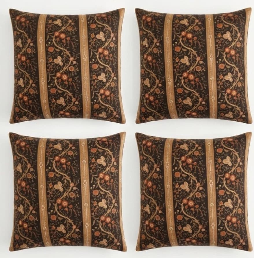 Black gold boho throw pillows with vertical stripes in orange, green, and floral patterns on a white background.